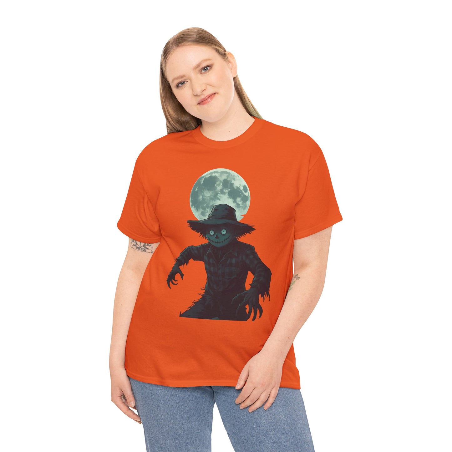 Halloween Scarecrow T-Shirt, This scarecrow shirt captures the essence of the season, transforming the traditional harvest icon into a pumpkin scarecrow that’s both captivating and chilling.Halloween