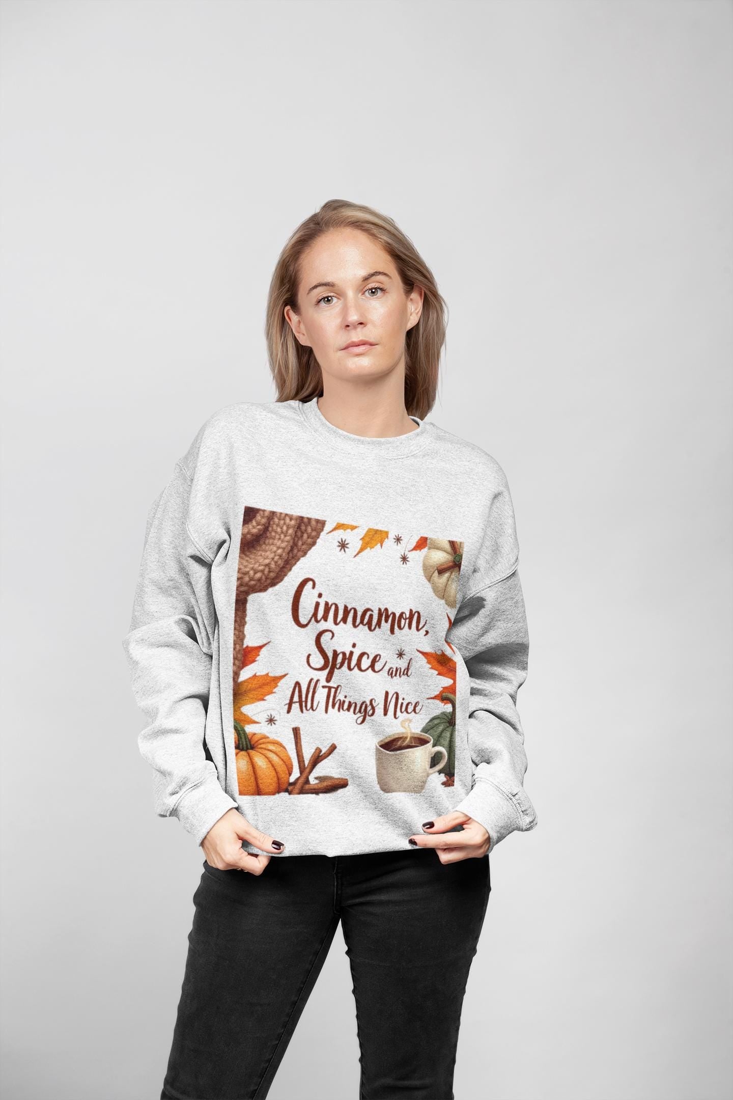 Cinnamon Spice and All Things Nice Sweatshirt, promises to keep you snug while adding a touch of seasonal charm to your wardrobe. Whether you’re sipping on a pumpkin latte or taking a leisurely stroll through fallen leaves,