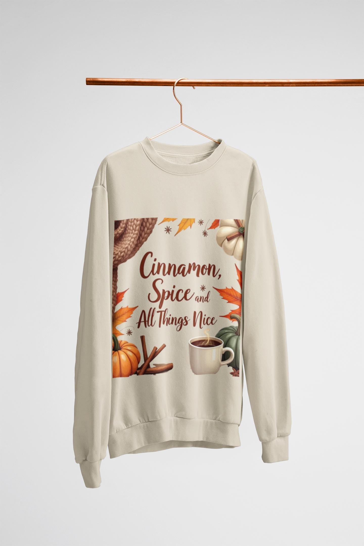 Cinnamon Spice and All Things Nice Sweatshirt, promises to keep you snug while adding a touch of seasonal charm to your wardrobe. Whether you’re sipping on a pumpkin latte or taking a leisurely stroll through fallen leaves,