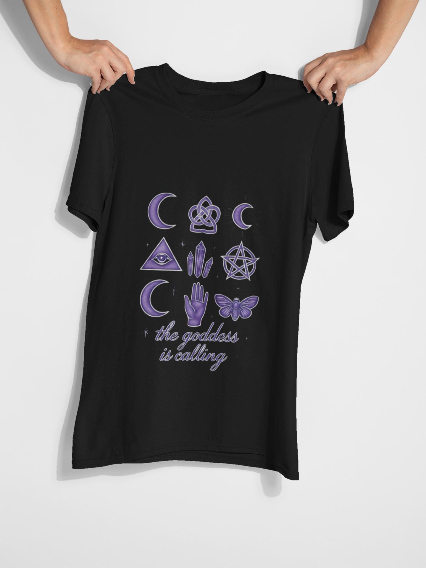 The Goddess is Calling Shirt, a celebration of divine feminine energy, seamlessly blending style and spirituality.