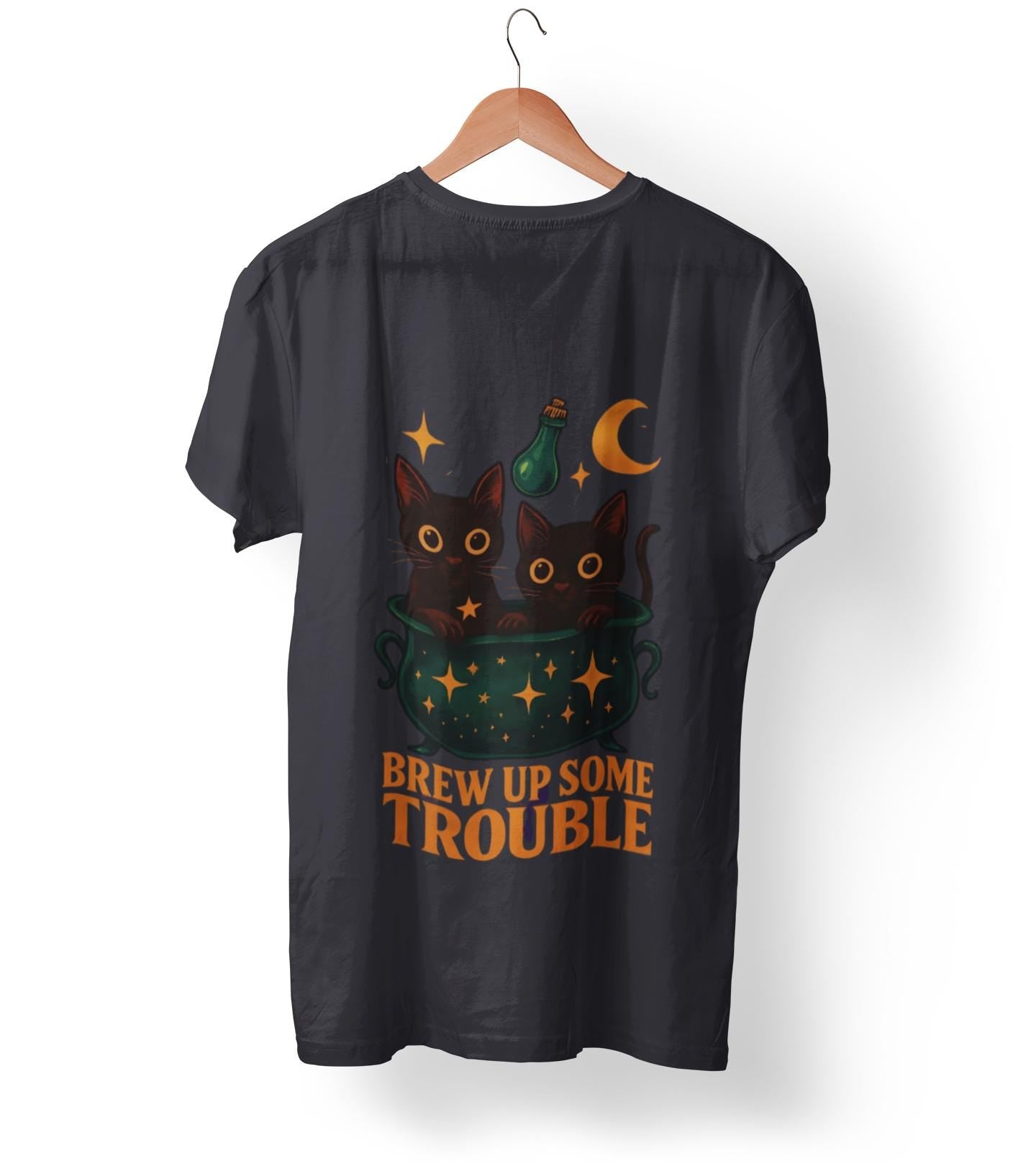 Brew Up Some Trouble Cat Witchy T-shirt, The seamless blend of mystical charm and humor makes this shirt a must-have for any lover of cute Halloween cat apparel.