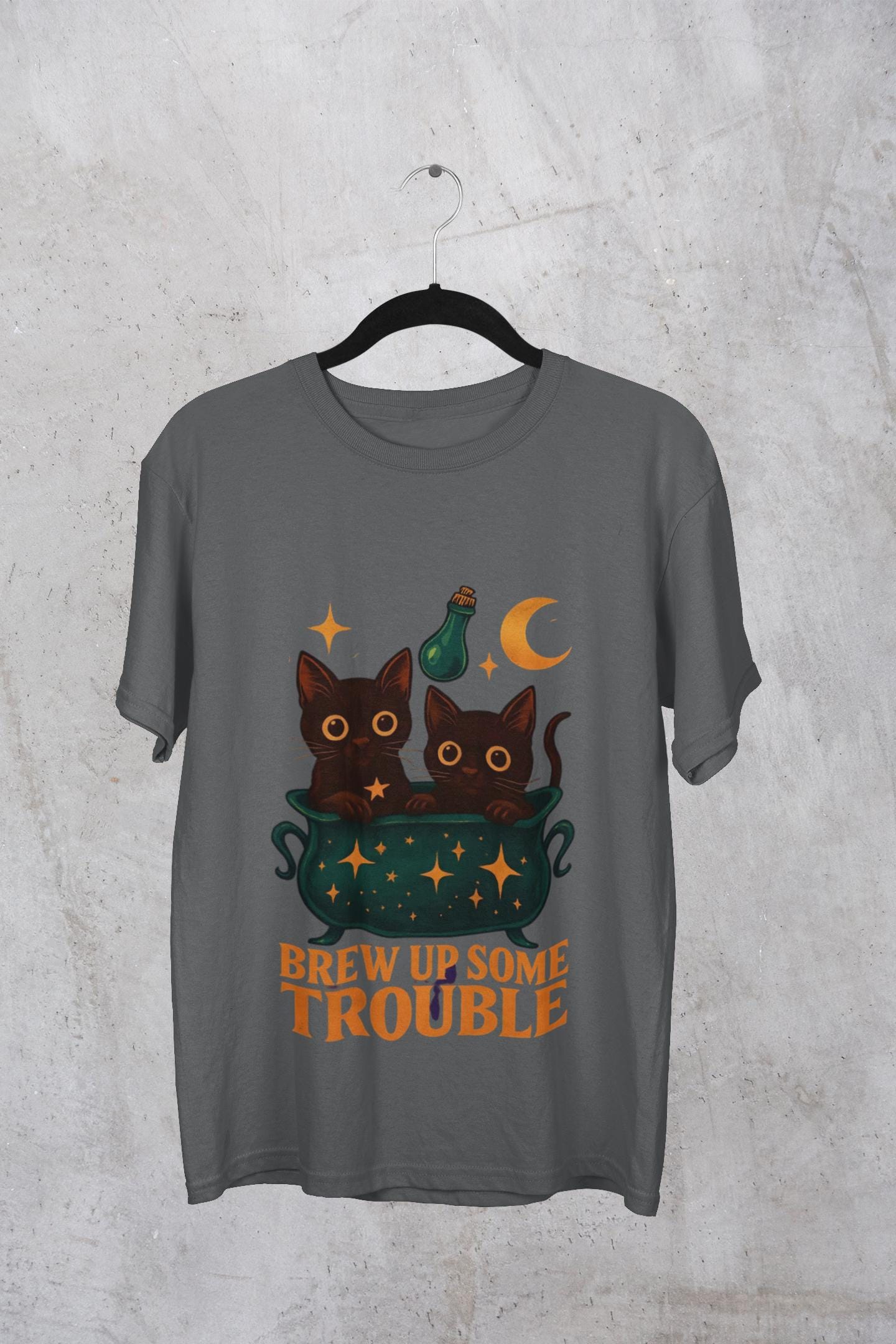 Brew Up Some Trouble Cat Witchy T-shirt, The seamless blend of mystical charm and humor makes this shirt a must-have for any lover of cute Halloween cat apparel.