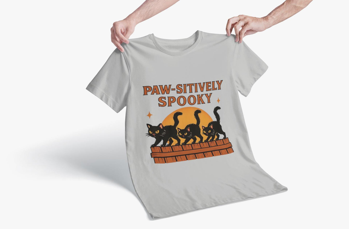 Paw-sitively Spooky Cat Tshirt, Whether you're a devoted cat dad or gifting it to a feline-loving friend, this cute Halloween cat apparel spreads pawsitive vibes with its blend of spooky black cats and cheeky charm.