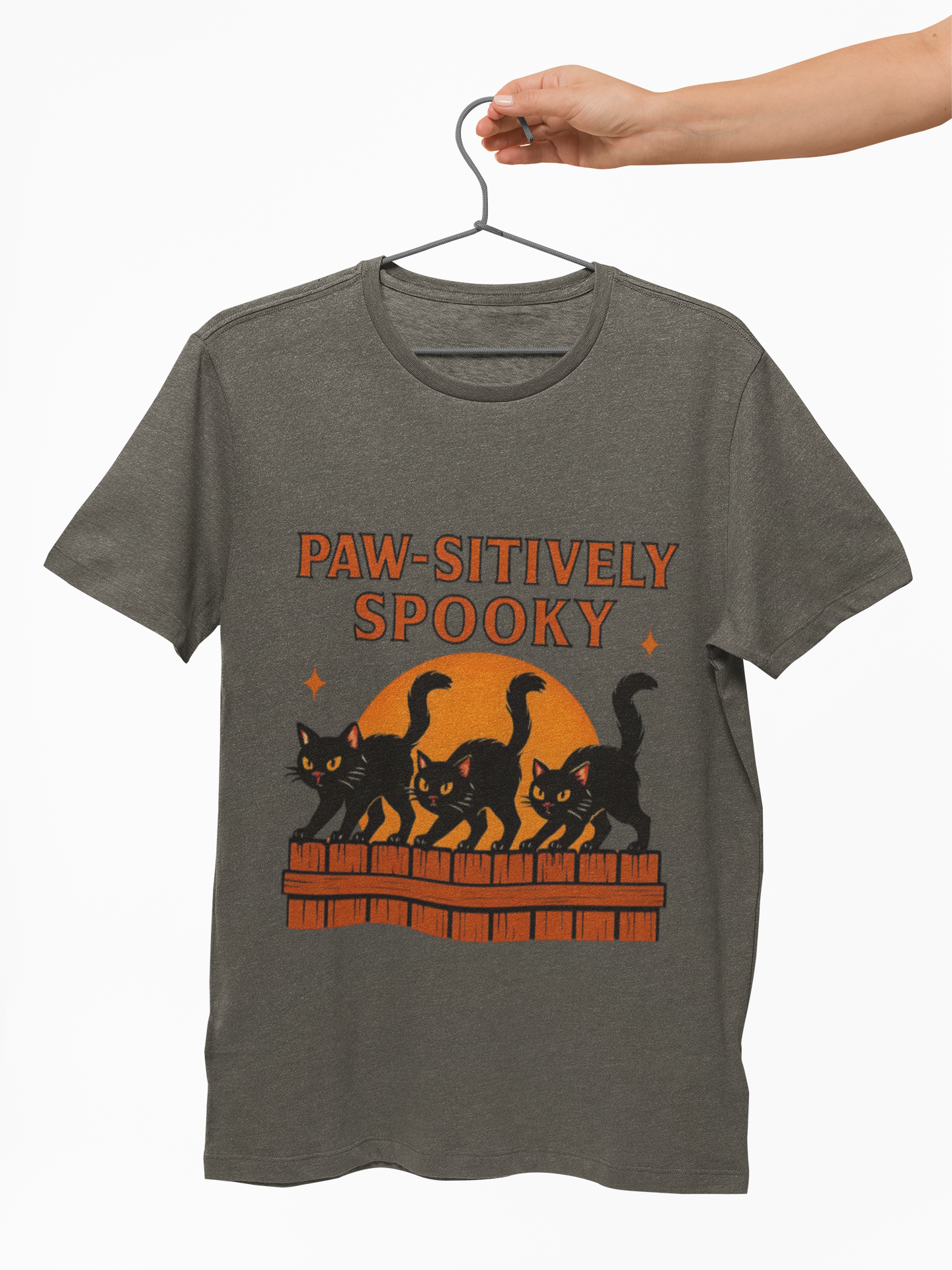 Paw-sitively Spooky Cat Tshirt, Whether you're a devoted cat dad or gifting it to a feline-loving friend, this cute Halloween cat apparel spreads pawsitive vibes with its blend of spooky black cats and cheeky charm.