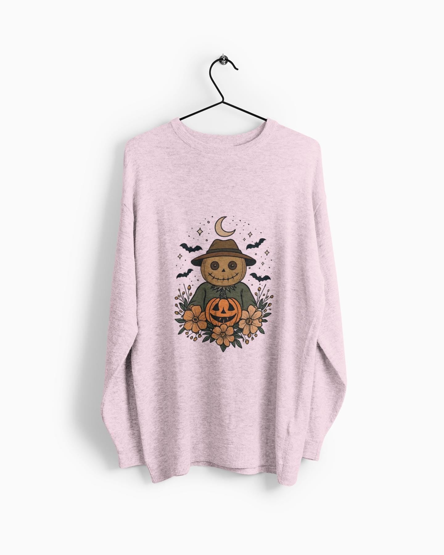 Cozy Halloween Sweatshirt with Scarecrow Design, The playful design featuring a whimsical scarecrow and autumnal elements creates a cheerful vibe, perfect for adding a festive touch to your wardrobe.