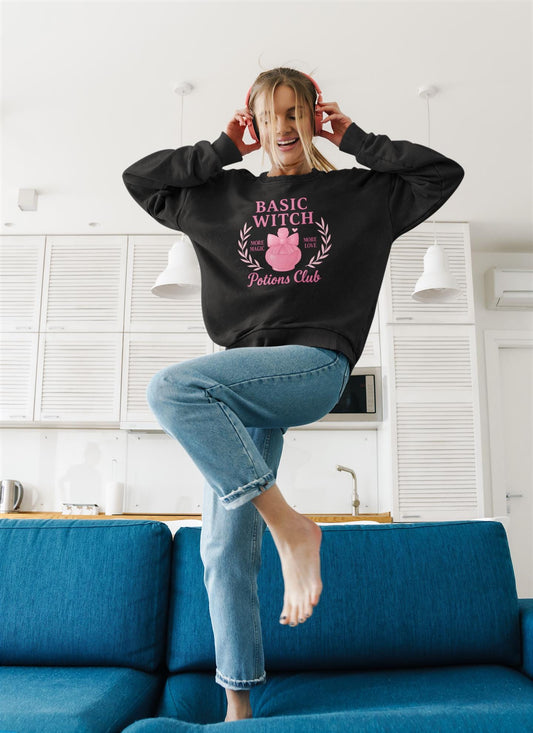 Basic Witch Potions Club Sweatshirt, This witchy sweatshirt exudes autumnal charm with its soft fabric that’s perfect for sweater weather, and features a whimsical potion bottle design reminiscent of a witches brew.